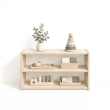 A low open two-shelf unit holding prepared trays: a bowl and spoon, a set of cards in a box, a cylinder block and a tray of cubes, with a stacking ring tower and a potted plant on top